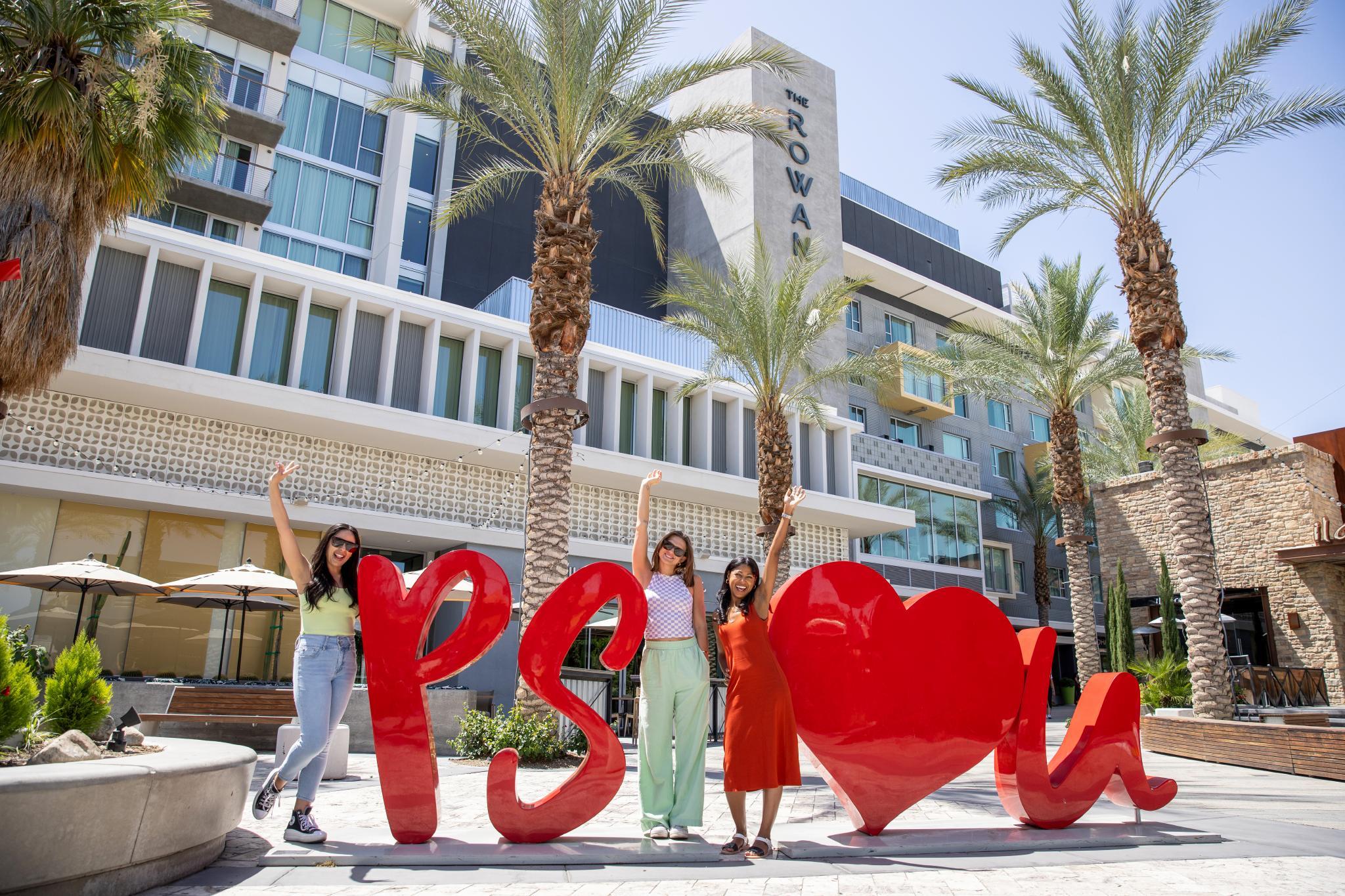 girls standing with letters that say ps i love you