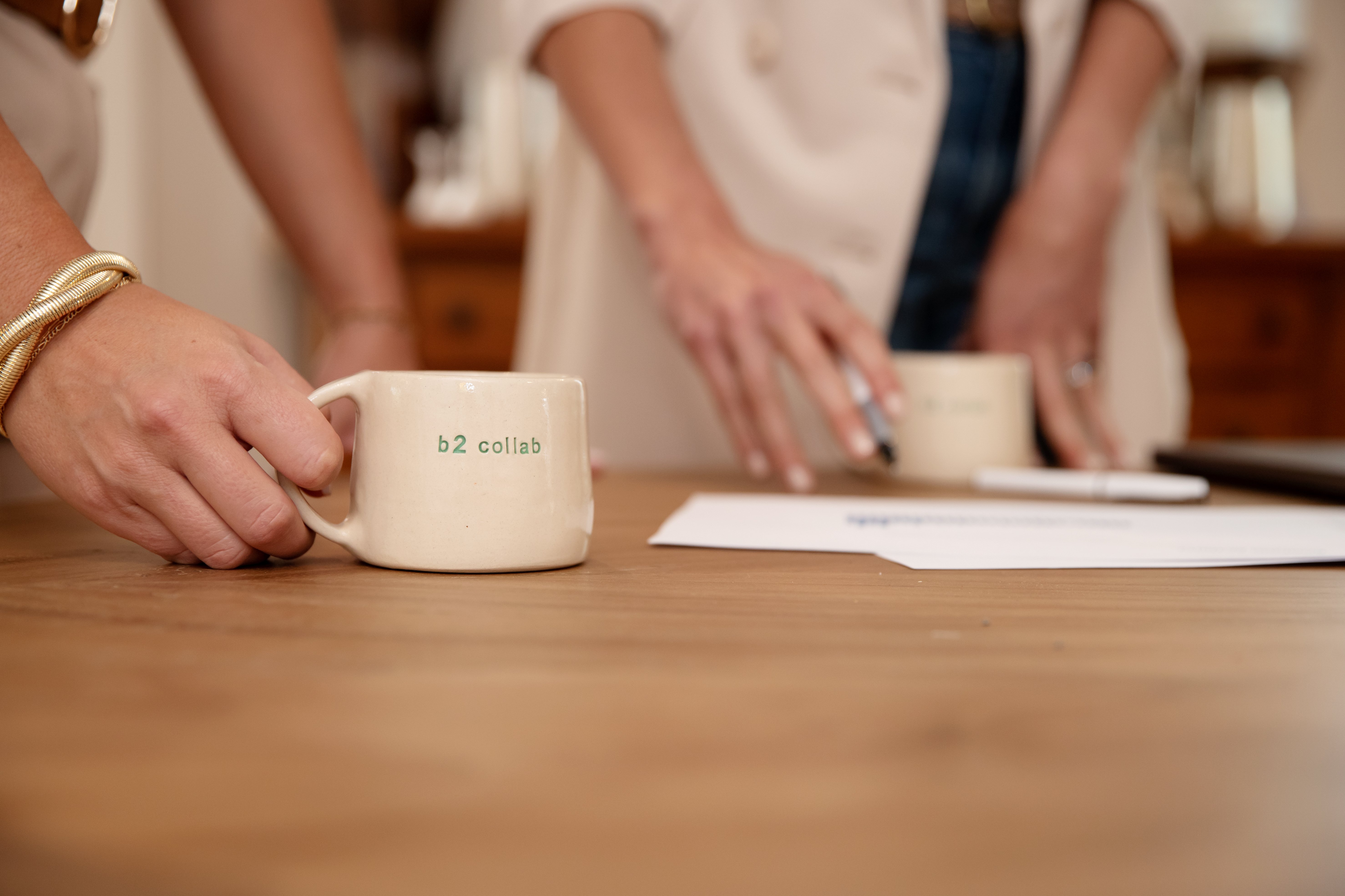 hands holding b2 collaborative coffee cups